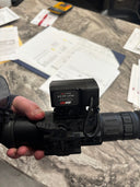 IRAY-AC05 thermal scope with serial #1194, held over a desk with documents and tools.