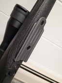 Close-up of a thermal rifle scope mounted on a textured gun stock, ideal for predator hunting gear.